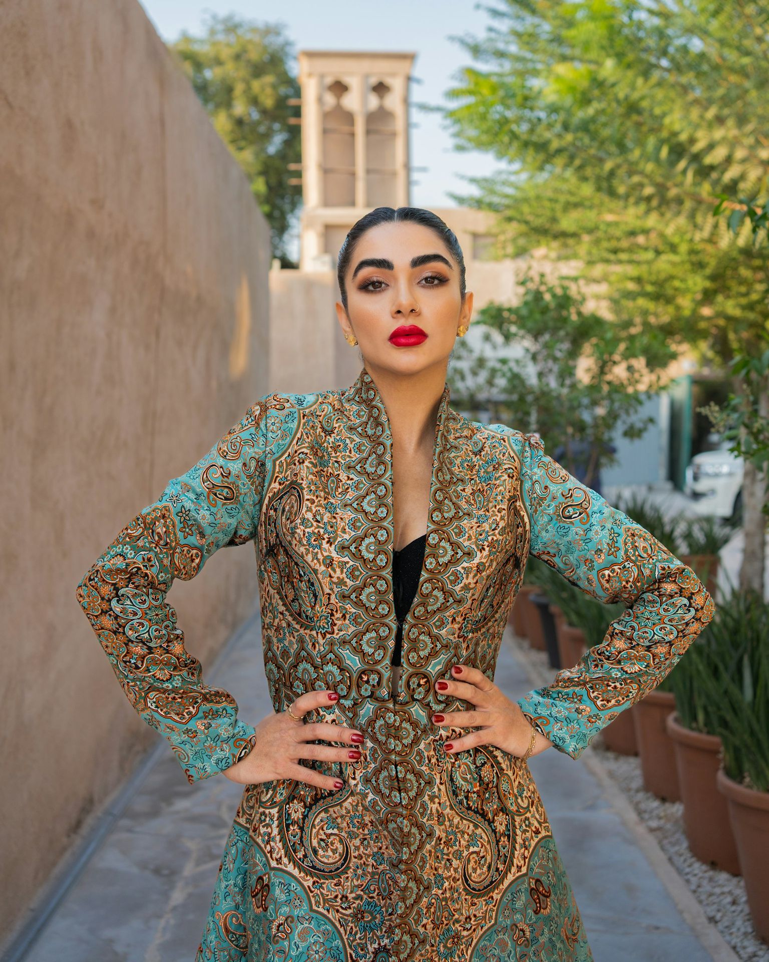 Beautiful woman poses in an ornate, patterned coat.